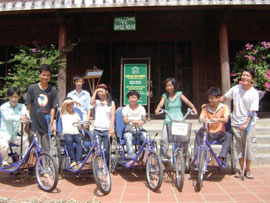 Smile House group photo with bicycles.