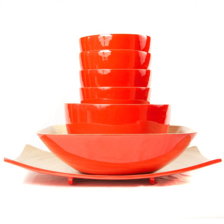 Full set of eco friendly red bamboo bowls in different sizes and a platter.